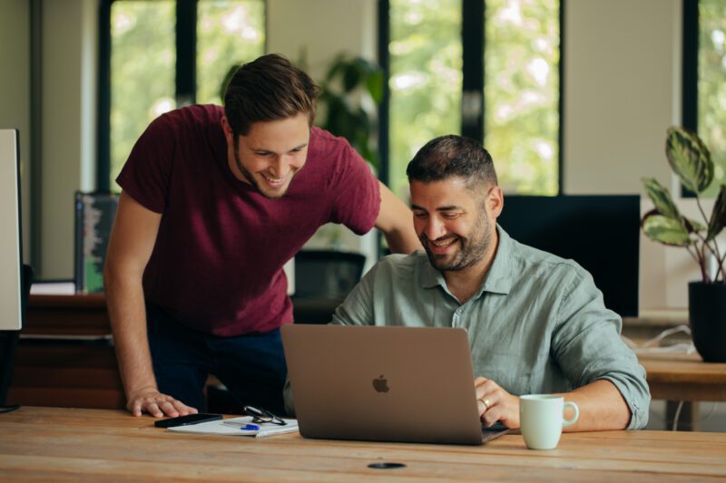 Joep & Deniz laughing and looking at a screen